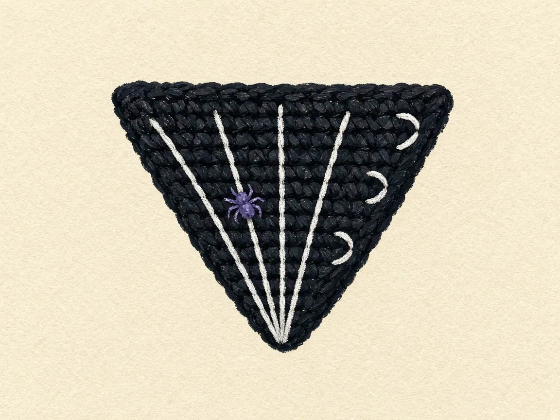 A black pointed flap with white lines from the tip and a small purple spider